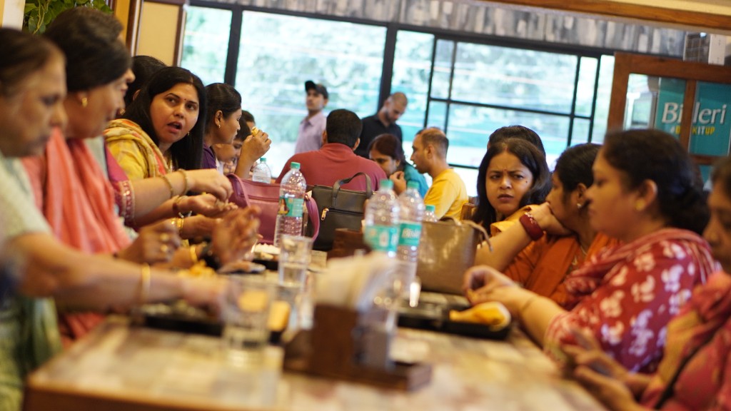 Guests sharing a meal together at a long dining table