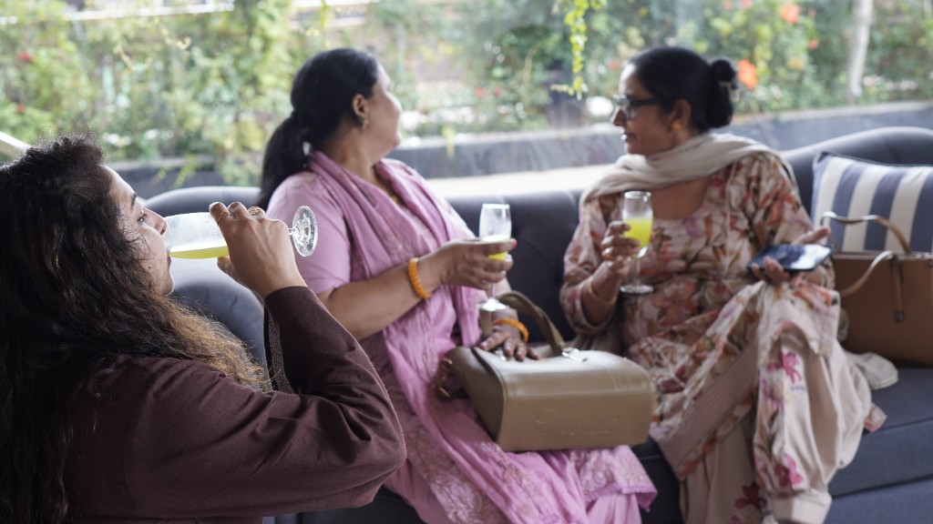 Guests talking over drinks in a hotel lounge