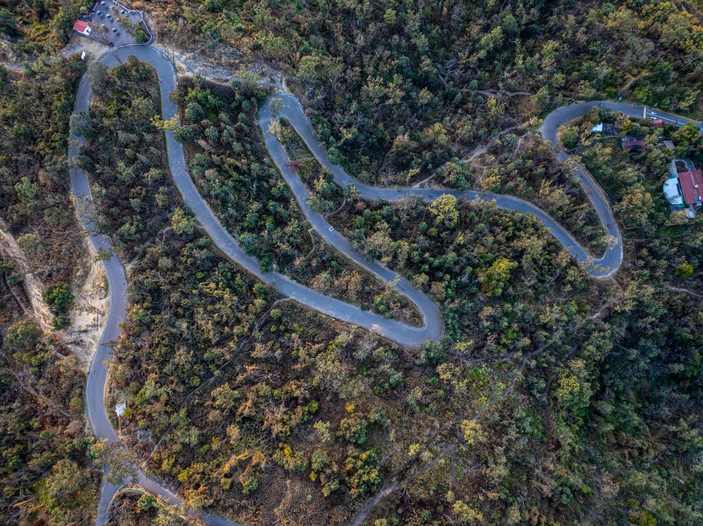 Hairpin bend mountain road into Nilgiri hills with shola forest