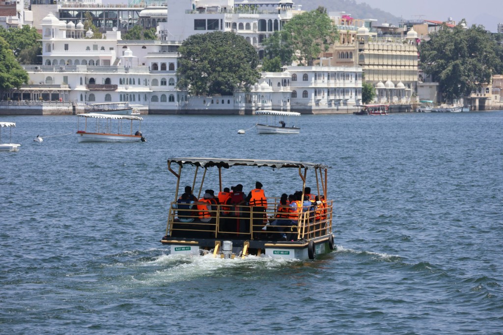 Lake Pichola boat ride with City Palace in the background at golden hour