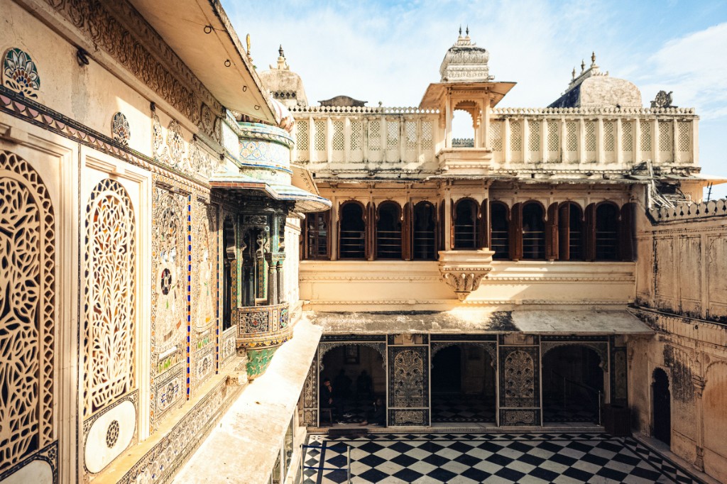 City Palace Udaipur courtyard with mosaic galleries and lake views